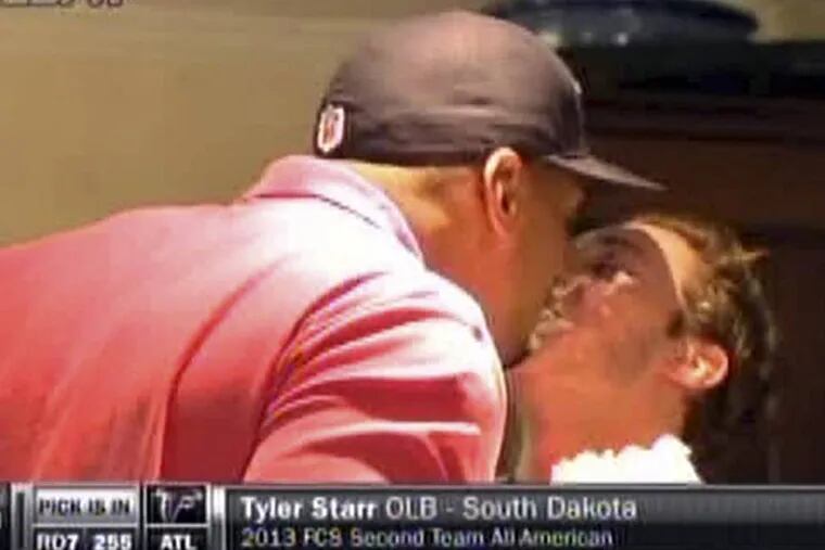In this image taken from video, Missouri defensive end Michael Sam, left, gets a kiss from his boyfriend at a draft party in San Diego before he was selected in the seventh round, 249th overall, by the St. Louis Rams in the NFL draft Saturday, May 10, 2014. The Southeastern Conference defensive player of the year last season came out as gay in media interviews this year. (AP Photo/ESPN)