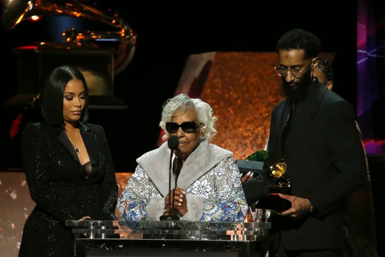 Lauren London, Margaret Boutte and Samiel Asghedom (from left to right) accept the award for best rap performance for "Racks in the Middle" on behalf of the late Nipsey Hussle.