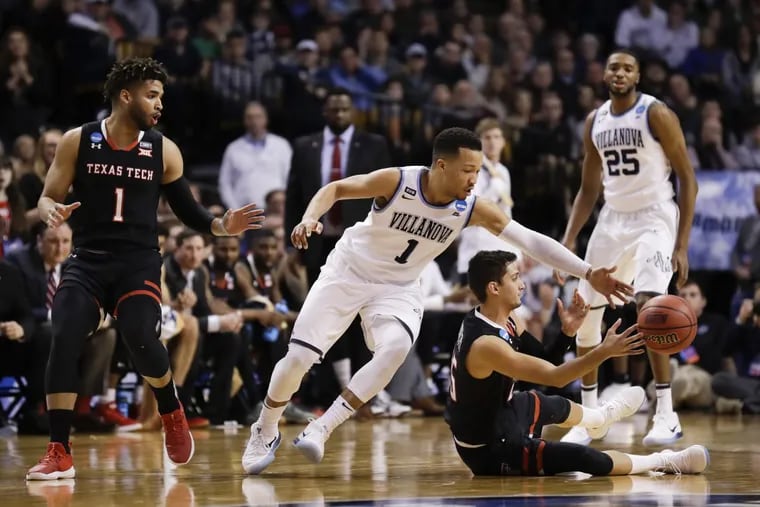 Villanova guard Jalen Brunson reaches for the basketball against Texas Tech guard Davide Moretti and past guard Brandone Francis (left) during the second-half in the East Regional Finals on Sunday, March 25, 2018 at the TD Garden in Boston.