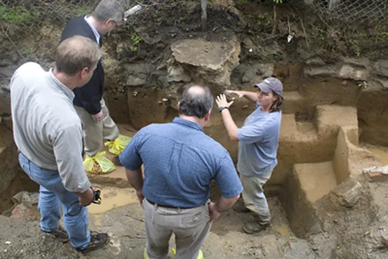 Kimberly Morell (right), manager for a PennDot contractor, reviews the Fishtown dig for local historians (from left) Rich Remer, Torben Jenk, and Kenneth Milano. (Ed Hille / Staff Photographer)