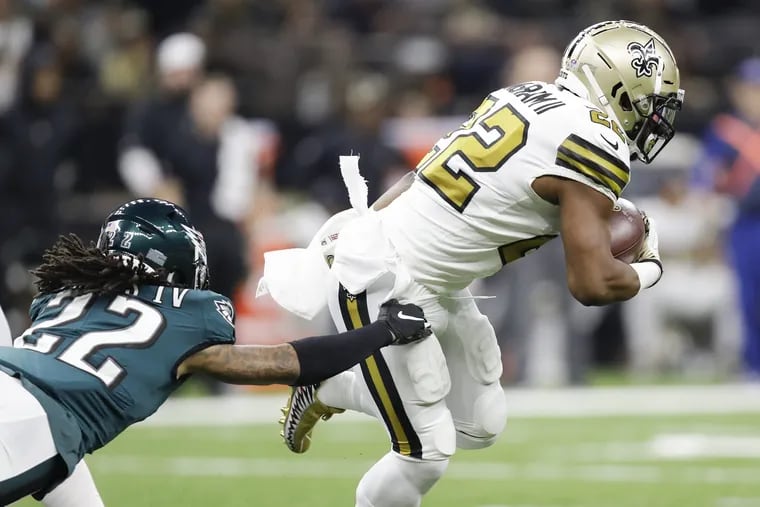 Mark Ingram evades a tackle attempt by Sidney Jones during the Eagles' loss on Sunday.