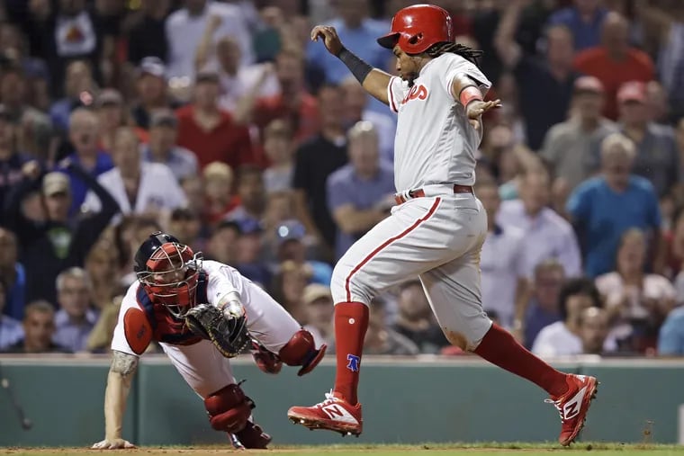 Phillies' third baseman Maikel Franco evades Red Sox catcher Blake Swihart's tag on Tuesday.