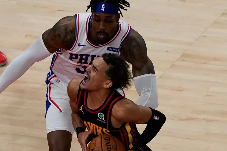 Atlanta Hawks guard Trae Young drives against Philadelphia 76ers center Dwight Howard during the first half of Monday's game.