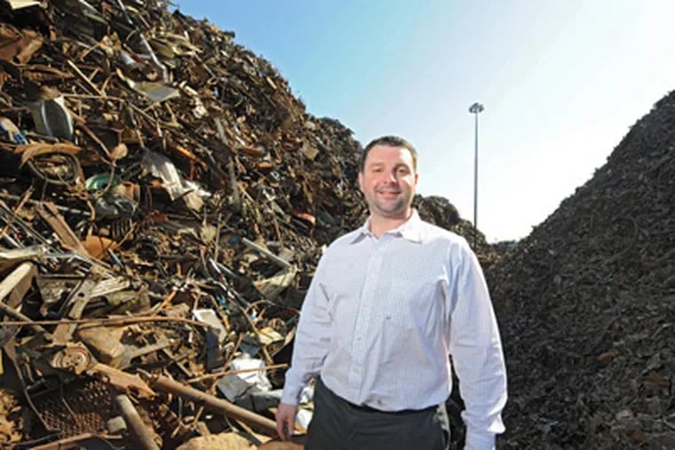 Joseph W. Balzano, president of Camden Iron & Metal, stands amid shredded steel that will disappear when the scrap recycler installs, by the end of this year, a modern shredder at Atlantic and Front Streets in Camden. (Clem Murray / Staff Photographer)