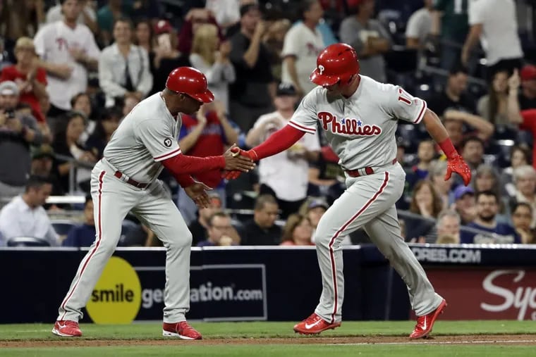 The Philadelphia Phillies' Rhys Hoskins, right, is greeted by third base coach Juan Samuel after hitting a home run during the fourth inning against the San Diego Padres on Monday, Aug. 14, 2017, in San Diego.