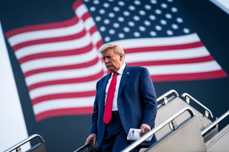 Former president Donald Trump disembarks his airplane, known as "Trump Force One," as he heads to speak an event at Trump National Golf Club Bedminster in Newark, N.J. in June.