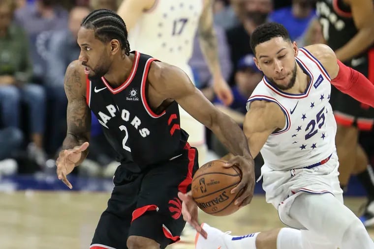 Sixers' Ben Simmons is about to knock the ball from  Raptors' Kawhi Leonard during the 3rd quarter of Game 3 of the second round of the NBA playoffs at the Wells Fargo Center in Philadelphia, Thursday, May 2, 2019.  Sixers beat the Raptors 116-95