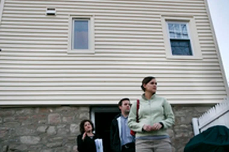 Real estate agent Cheryl Miller, left, shows Tim and Jen Raybould an Abington house that&#0039;s listed for sale at $249,900.