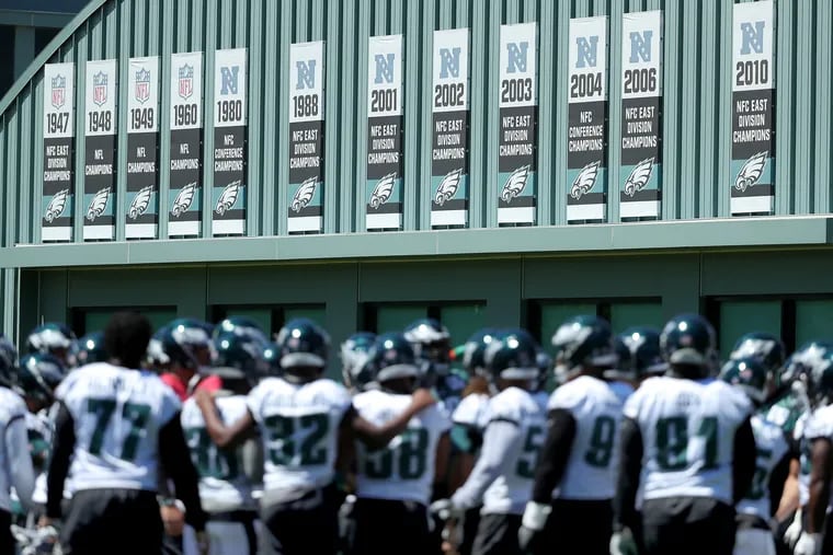Eagles' players gather with their past championship banners behind them during the last day of the Eagles three-day mandatory minicamp in Philadelphia, PA on June 13, 2018. DAVID MAIALETTI / Staff Photographer