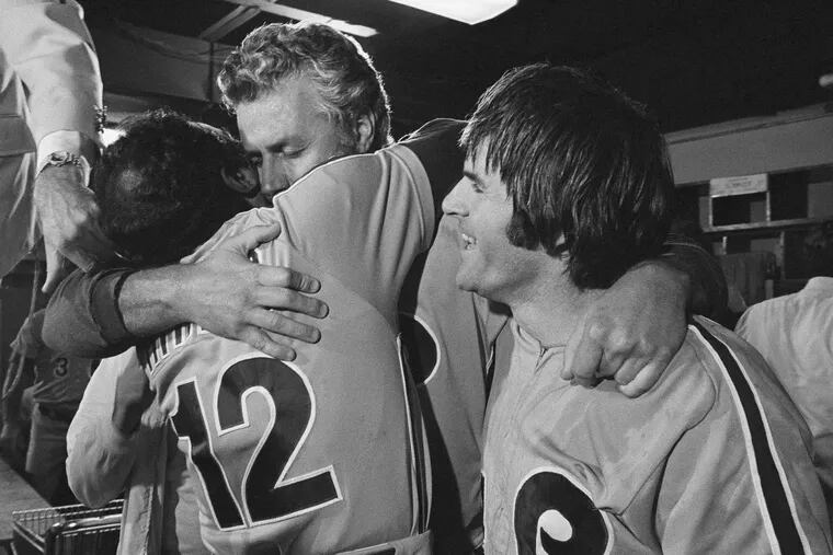 Philadelphia Phillies manager Dallas Green, center, is hugged by Coach Ruben Amaro, left, and congratulated by first baseman Pete Rose, right, after the Phillies won the National League Championship Series in Houston on Sunday, Oct. 13, 1980.
