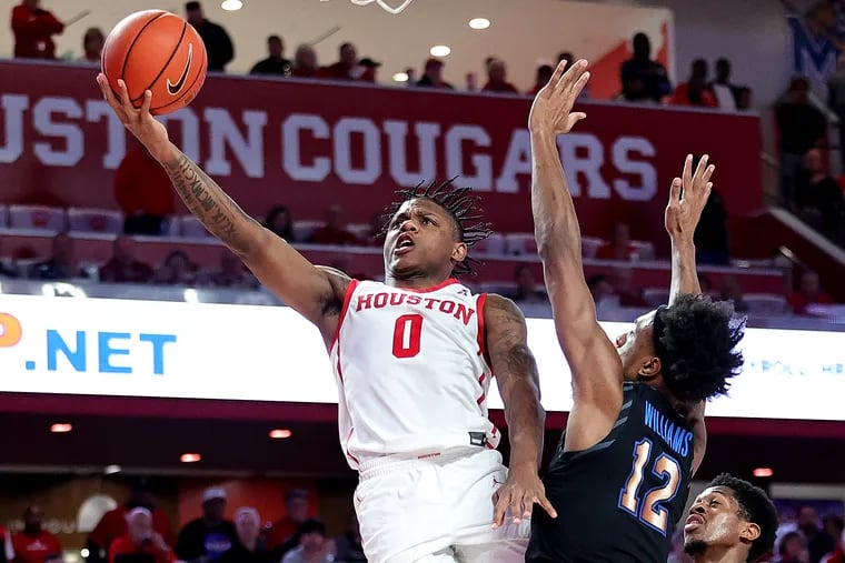 Houston Cougars guard Marcus Sasser puts up a shot over Memphis guard DeAndre Williams during a game earlier this month. Houston is the odds-on favorite to win next week’s American Athletic Conference Tournament, while the Tigers are the second choice. (Photo by Bob Levey/Getty Images)