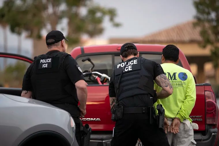 In this July 8, 2019, photo, a U.S. Immigration and Customs Enforcement (ICE) officers detain a man during an operation in Escondido, Calif.  A sweeping expansion of deportation powers unveiled this week by the Trump administration has sent chills through immigrant communities and prompted some lawyers to advise migrants to gather up as much documentation as possible -- pay stubs, apartment leases or even gym key tags -- to prove they’ve been in the U.S.