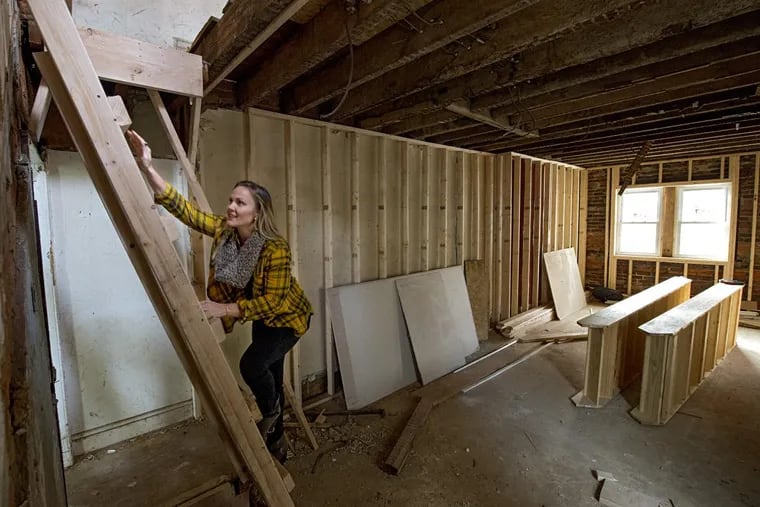Philadelphia home flipper Kelly Straka, 32, climbs a 2 x 4 ladder to the 2nd floor of a home she gutted and was completely renovating in the spring on E. Susquehanna Street in the Fishtown neighborhood of Philadelphia. Philadelphia is one of the hottest home-flipping markets in the nation. (CLEM MURRAY / Staff Photographer)