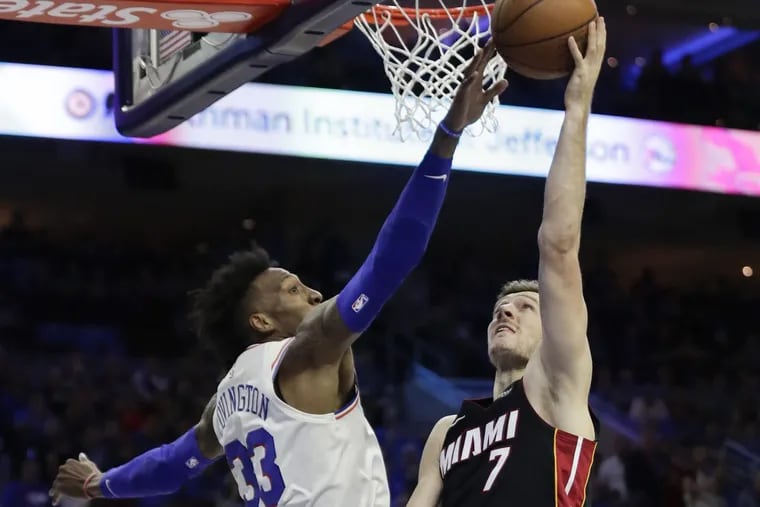 Sixers forward Robert Covington blocks Miami Heat guard Goran Dragic’s layup during the Sixers’ win on Saturday.