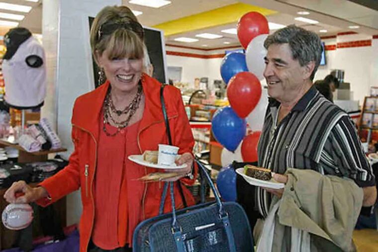 Dianna Hawkins and Jim Stabene of Langhorne, Bucks County, with the free snacks they received from the newly opened Euro Cafe after landingat Atlantic City International Airport.