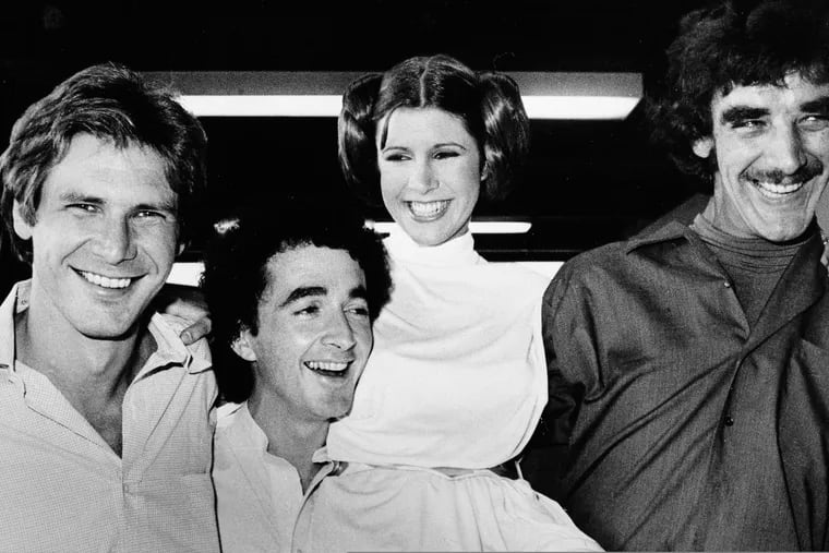 FILE - In this Oct. 5, 1978, file photo, actors featured in the "Star Wars" movie (from left) Harrison Ford, who played Han Solo; Anthony Daniels, who played the robot C3P0; Carrie Fisher, who played the princess; and Peter Mayhew, who played the Wookie, Chewbacca, are shown during a break from the filming of a television special presentation in Los Angeles. Mayhew’s family said in a statement that he died at his home in Texas on Friday, April, 26, 2019. He was 74. No cause was given.