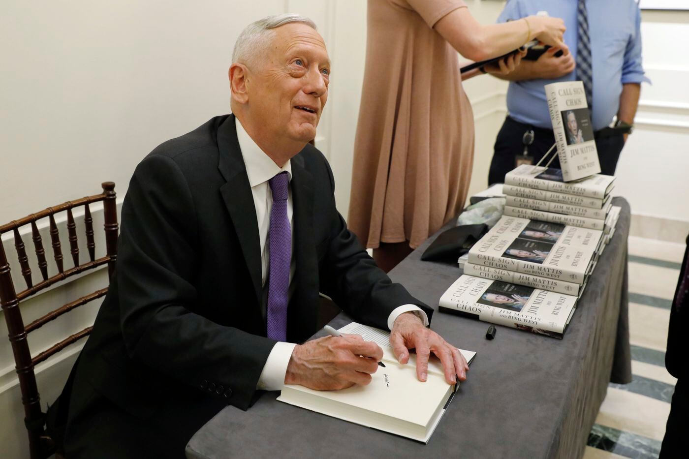 Former U.S. Secretary of Defense Jim Mattis signs copies of his book after he spoke at the Council on Foreign Relations, in New York, Tuesday, Sept. 3, 2019. 