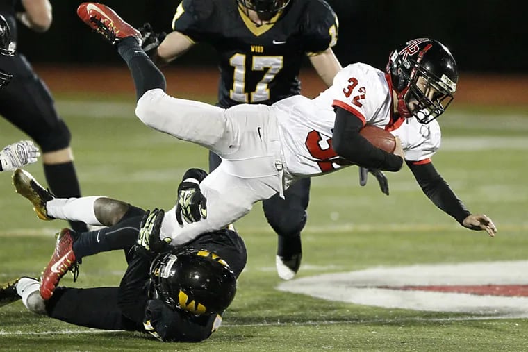Gianni Cruel, left, of Archbishop Wood up ends Mike Minnitiof
Archbishop Ryan in the 1st quarter of the Catholic League Class AAA
Final at William Tennent on Nov. 19, 2015. Mack Schwartz, #17, closes
is in the background.