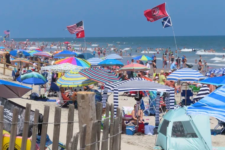 Beachgoers enjoy the sand and surf in North Wildwood N.J. last year on July 7. This summer only umbrellas will be allowed on the beach.