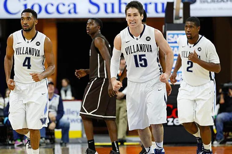 Villanova's Ryan Arcidiacono, center, reacts as time is called with Darrun Hilliard II, left, and Kris Jenkins, right, during the second half of an NCAA college basketball game against the Lehigh, Friday, Nov. 14, 2014, in Allentown, Pa. Villanova won 77-66. (Chris Szagola/AP)