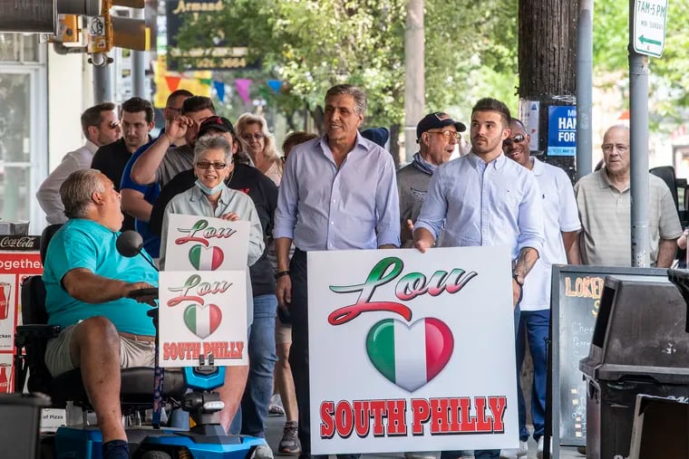 Pennsylvania Republican gubernatorial candidate Lou Barletta, center, talks to residents and business owners as he campaigns in the Italian Market in South Philadelphia on Tuesday.