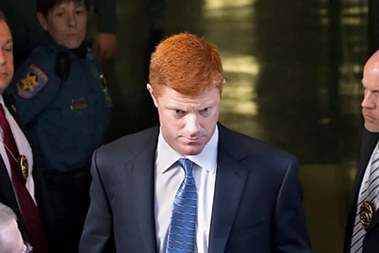 Assistant football coach Mike McQueary leaves court in Dauphin County. He testified he was clear in telling two Penn State officials what he saw Jerry Sandusky doing. (Joe Hermitt / Harrisburg Patriot-News)
