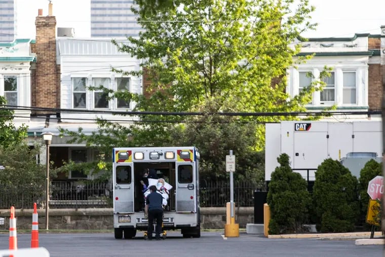 An ambulance is unloaded at the Philadelphia Nursing Home on Girard Avenue in May. Gov. Tom Wolf said he might consider "targeted" restrictions aimed at nursing home and other facilities.
