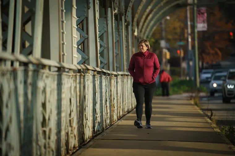 Alexandra Hackett, shown here during her morning walk on the Falls Bridge in November, experienced long COVID symptoms that have made her doubt she could return to running.