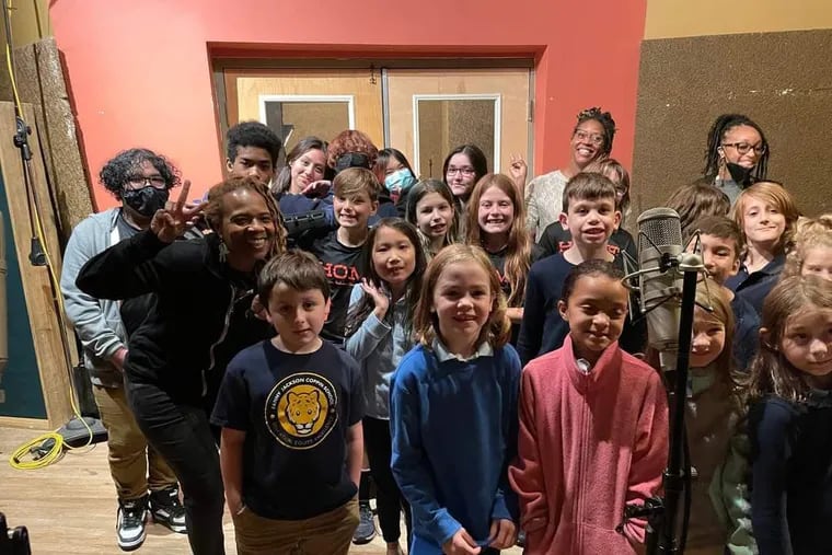The Fanny Jackson Coppin School second graders at their MilkBoy recording session last year with recording artist and lead singer Divinity Roxx giving a peace sign and teacher Danielle Harrigan and student teacher Aja Bing at rear right.