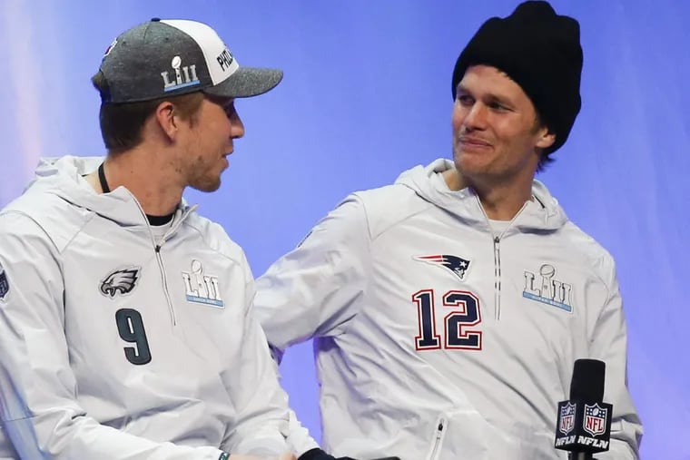 Eagles quarterback Nick Foles and New England Patriots quarterback Tom Brady meet during a interview before the Eagles start their media night on Monday, January 29, 2018 at the Xcel Energy Center in St. Paul, Minn.