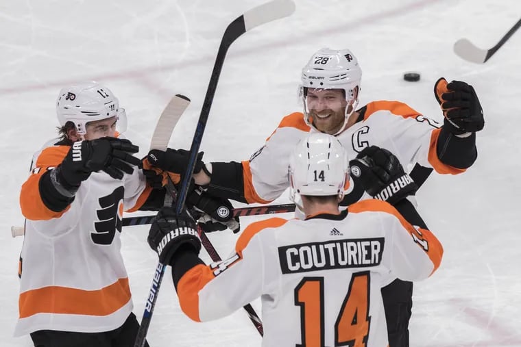 Flyers Travis Konecny (11) and Claude Giroux (28) congratulate Sean Couturier (14) after he scored against the Arizona Coyotes on Monday. The Flyers ended the Coyotes' five-game winning streak, 5-2.