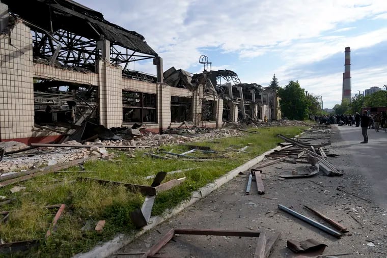 Wreckage lies along a street at a railway service facility hit by a Russian missile strike in Kyiv, Ukraine, Sunday, June 5, 2022.