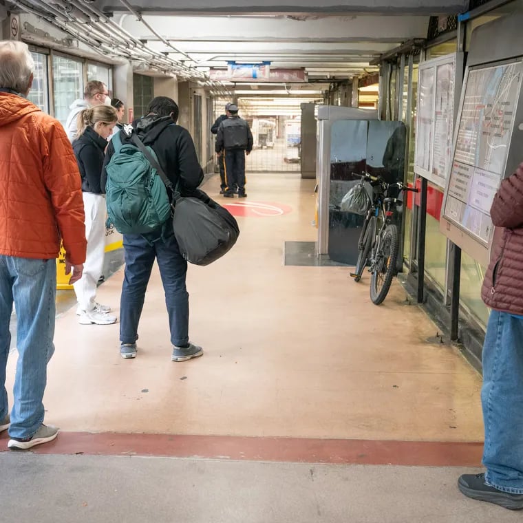 People wait at the Eighth and Market PATCO station after service was suspended on April 5 because of the earthquake.