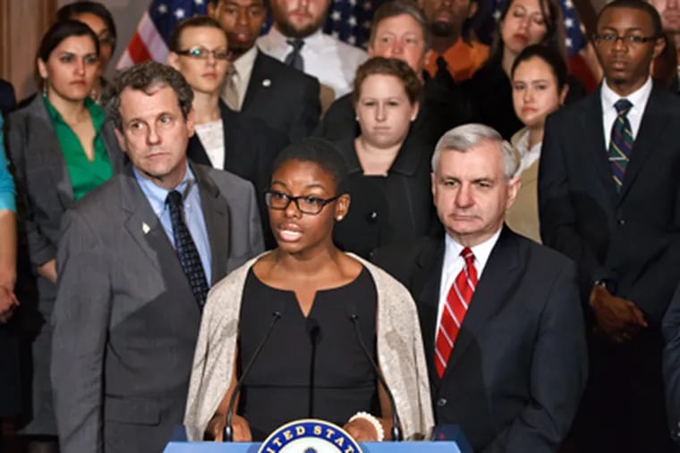Clarise McCants of Philadelphia and Howard University is flanked by Democratic Sens. Sherrod Brown (left) and Jack Reed on Capitol Hill on Tuesday. J. SCOTT APPLEWHITE / AP