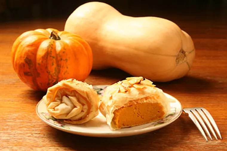 Pumpkin almond strudel, surrounded by a variety of squashes. (CHARLES FOX / Staff Photographer)
