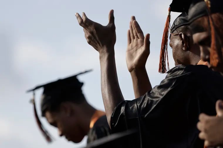 Graduates applaud each other immediately following the Class of 2022 Woodrow Wilson H.S. graduation ceremony at Woodrow Wilson H.S. in Camden, N.J., in late June.