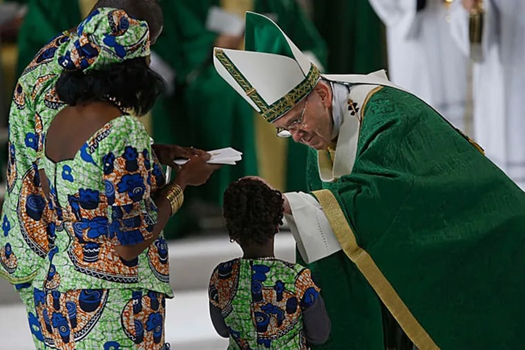 Pope Francis blesses a child who delivered the Eucharist for yesterday's papal Mass.