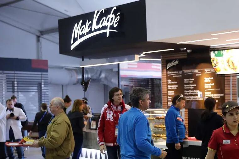 Athletes and coaches visit a McDonald's inside the Olympic Village dining hall in Sochi.