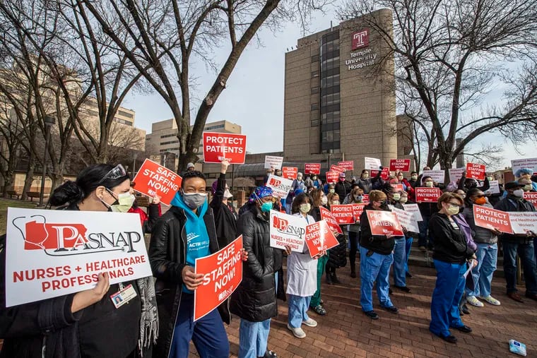 Healthcare workers protest during a rally in January.
