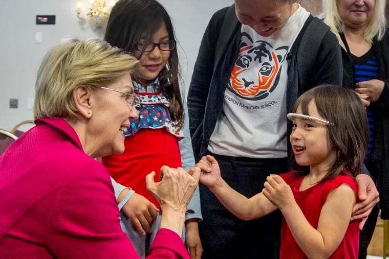 Democratic presidential candidate Sen. Elizabeth Warren gets on her knees to "pinky swear" with 5-year-old Sarah Buse-Morley saying "that's what girls do," when talking about running for president, following a meeting with members of the American Federation of Teachers, at the Plumbers Local 690 Union Hall in Northeast Philadelphia on May 13, 2019. Sarah's mom, Meredith Buse (rear) teaches first grade at Vare-Washington Elementary School. Her other daughter is Rebecca Buse-Morley (rear, left), 8.