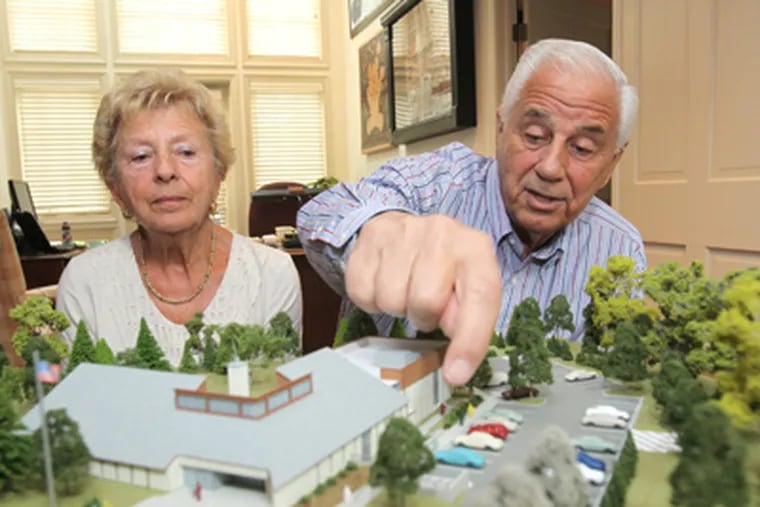 Athena and Nicholas Karabots are shown with a model of the William Jeanes Memorial Library in the offices at their estate, Karamoor Farm. (Charles Fox / Staff Photographer)