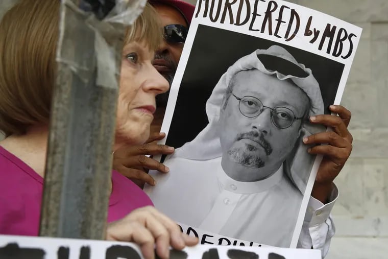 In this Oct. 10, 2018, file photo, people hold signs during a protest at the Embassy of Saudi Arabia about the disappearance of Saudi journalist Jamal Khashoggi, in Washington.