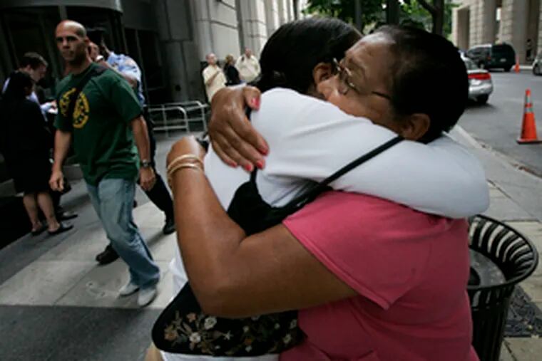 Embracing after a preliminary hearing, Mirta Rodriguez (left), mother of slain teen Mark Anthony Rivera, clings to her mother, Elba Jorge, outside the Criminal Justice Center yesterday.