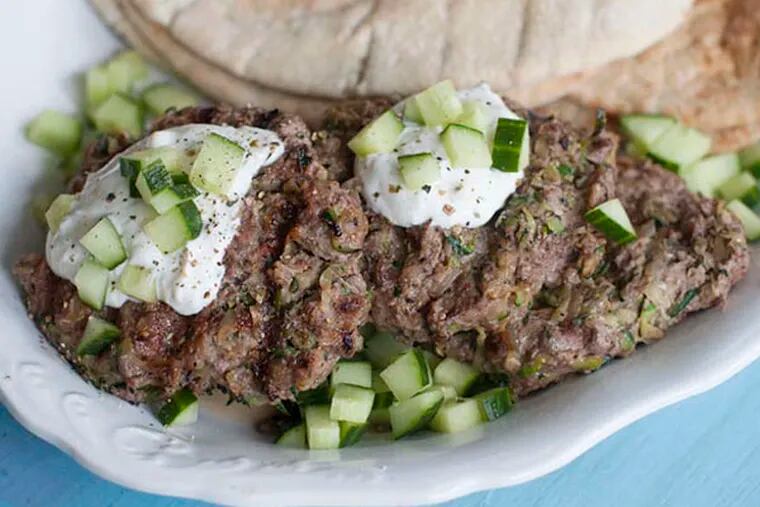 Grilled Middle Eastern lamb burgers with garlic sauce, served in pita bread.