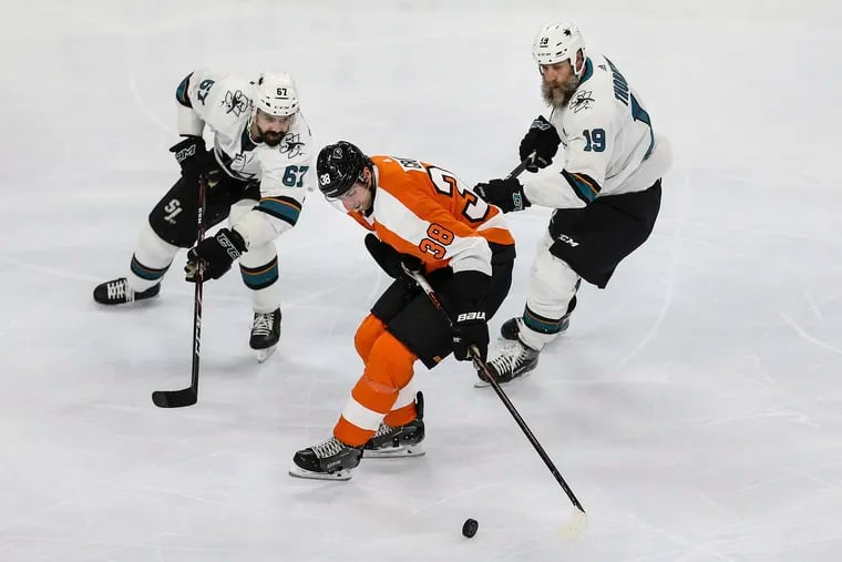 Flyers center Derek Grant is surrounded by San Jose's Jacob Middleton (67) and Joe Thornton (19) during the third period. The Flyers won, 4-2, Tuesday night for their fourth straight victory.