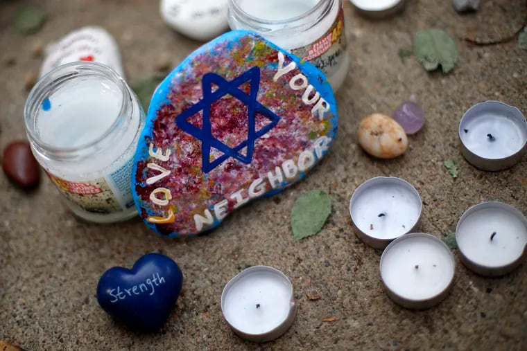 This is a painted rock found Wednesday, Oct. 31, 2018, part of a makeshift memorial outside the Tree of Life Synagogue in the Squirrel Hill neighborhood of Pittsburgh, to the 11 people killed during worship services Saturday Oct. 27, 2018.