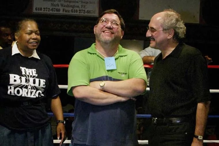 Daily News boxing writer Bernard Fernandez reacting to a birthday cake in his honor at the Blue Horizon with co-owner Vernoca Michael, left, and Daily News Editor Zack Stalberg, right, in September 2002.