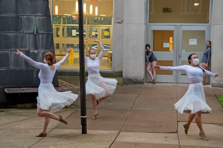Dancers perform "Ying & Yang," one of the works in "Sites of Dance" at Drexel Thursday. Audience members were only able to see one of the seven works before thunder and lighting closed down the show. Performances continue Friday, Saturday, and Sunday evening, weather permitting.