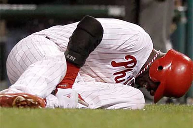 Ryan Howard collapsed after injuring his Achilles and making the Phillies'  last out against the Cardinals in the NLDS. (Yong Kim / Staff Photographer)