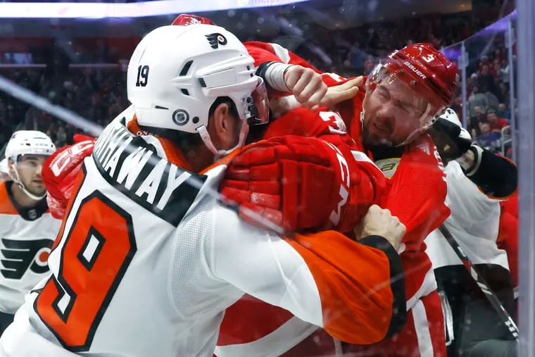 Detroit Red Wings defenseman Justin Holl (3) tries to punch Philadelphia Flyers right wing Garnet Hathaway (19) during the first period.